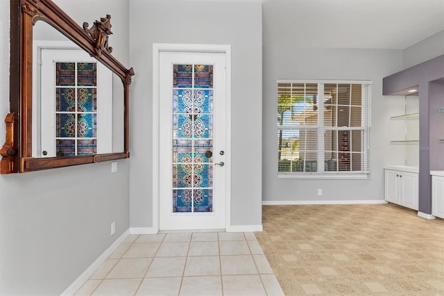 foyer entrance featuring tile patterned flooring and baseboards