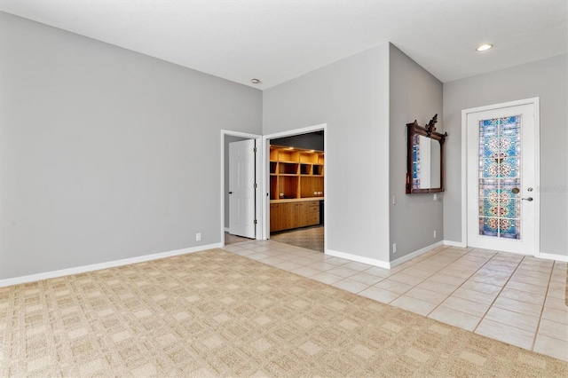 carpeted spare room with tile patterned floors, recessed lighting, and baseboards