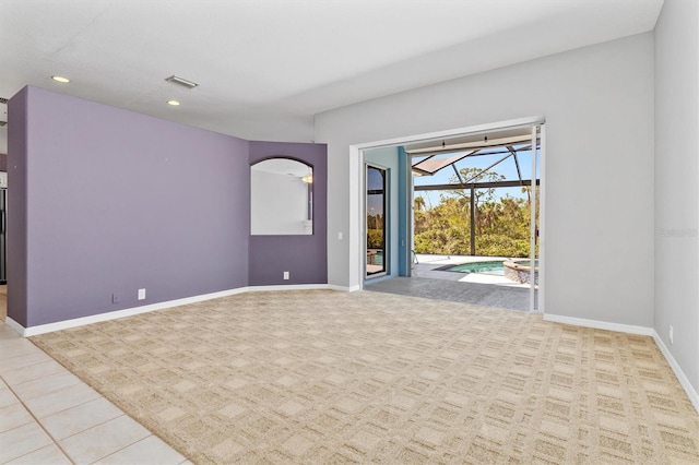 unfurnished room featuring visible vents, baseboards, recessed lighting, a sunroom, and arched walkways