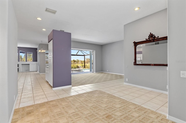 carpeted empty room featuring tile patterned floors, visible vents, plenty of natural light, and recessed lighting