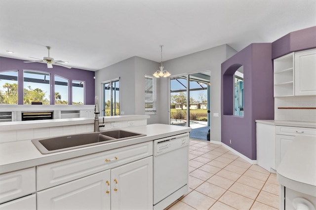 kitchen featuring a sink, tasteful backsplash, white dishwasher, light countertops, and light tile patterned floors