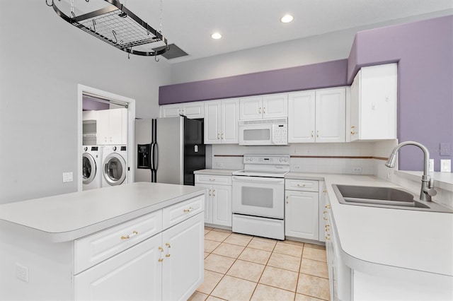 kitchen featuring a sink, white appliances, separate washer and dryer, light tile patterned flooring, and light countertops