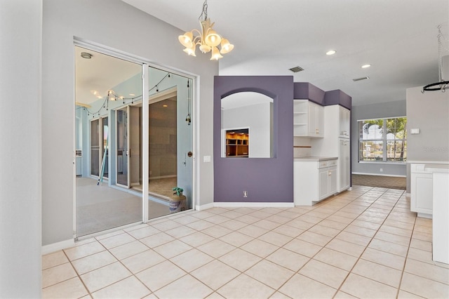 interior space with decorative light fixtures, light countertops, light tile patterned floors, white cabinets, and open shelves