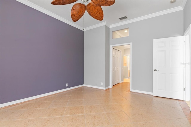 unfurnished room featuring light tile patterned flooring, baseboards, visible vents, and ornamental molding