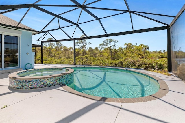 view of pool featuring a lanai, a patio area, and a pool with connected hot tub