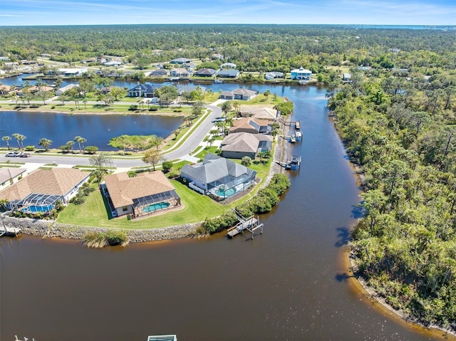 bird's eye view with a forest view and a water view