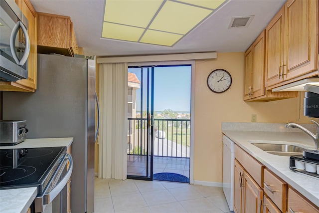 kitchen with visible vents, light countertops, appliances with stainless steel finishes, light tile patterned flooring, and a sink