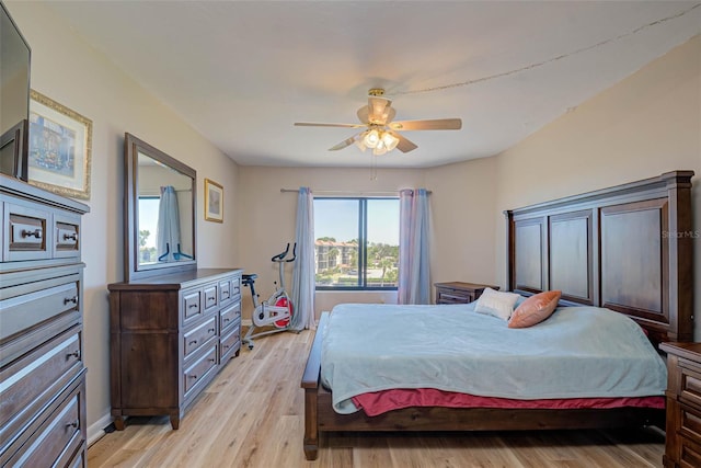 bedroom featuring light wood finished floors, baseboards, and ceiling fan