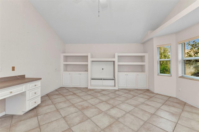 interior space featuring baseboards and lofted ceiling