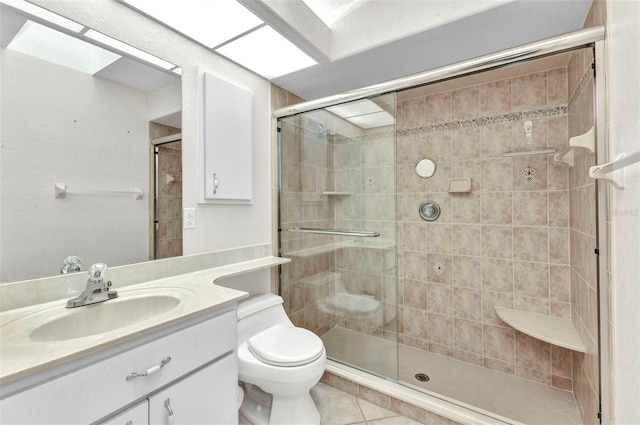 full bath featuring tile patterned flooring, toilet, a stall shower, and vanity