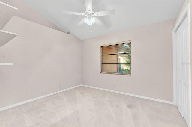 empty room with baseboards, carpet, a ceiling fan, and vaulted ceiling