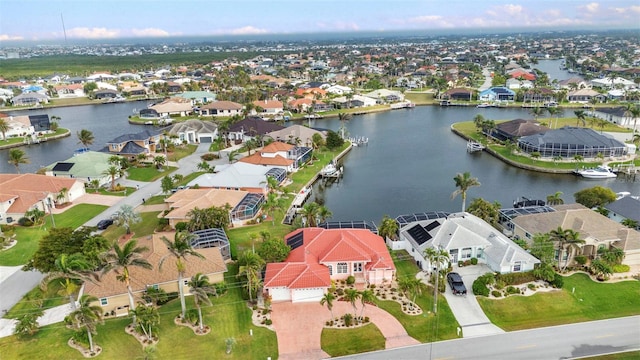 drone / aerial view featuring a residential view and a water view