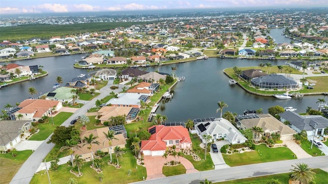 birds eye view of property featuring a residential view and a water view