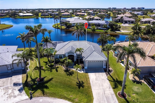 birds eye view of property featuring a residential view and a water view