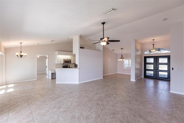 unfurnished living room featuring visible vents, baseboards, ceiling fan with notable chandelier, french doors, and high vaulted ceiling