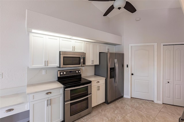 kitchen with stainless steel appliances, white cabinets, light countertops, lofted ceiling, and ceiling fan