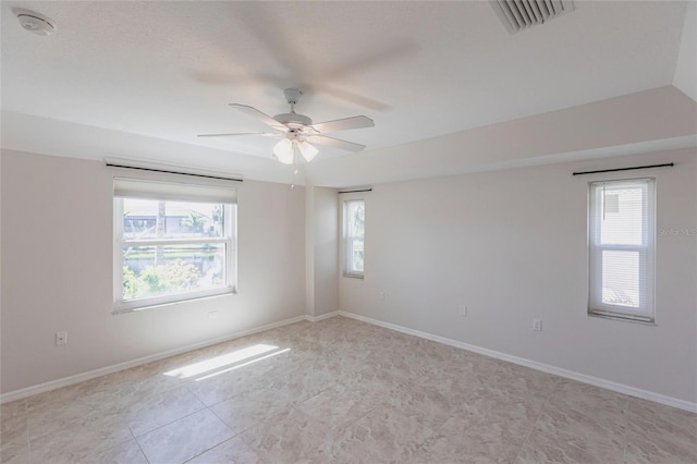 spare room with visible vents, baseboards, and a healthy amount of sunlight