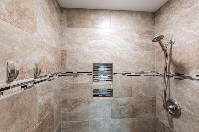 bathroom with a tile shower