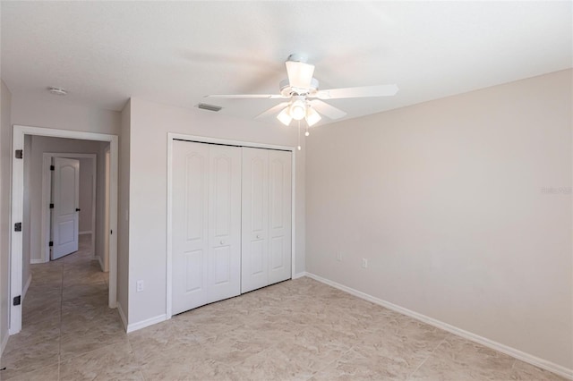 unfurnished bedroom with a closet, visible vents, a ceiling fan, and baseboards