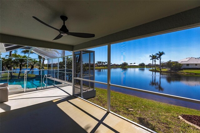 unfurnished sunroom with a water view and ceiling fan