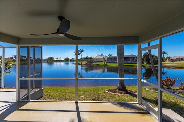 sunroom / solarium with a wealth of natural light, ceiling fan, and a water view