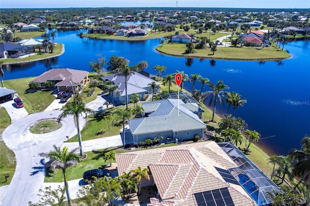 birds eye view of property featuring a water view and a residential view