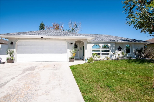 single story home featuring a front yard, driveway, an attached garage, a shingled roof, and stucco siding