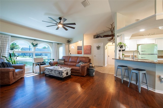 living area featuring dark wood-style floors, visible vents, and ceiling fan