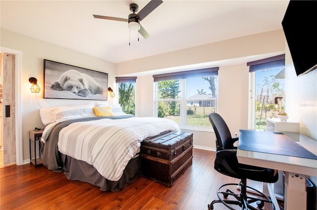 bedroom with hardwood / wood-style flooring, baseboards, and ceiling fan