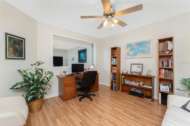 office with light wood-type flooring, baseboards, a textured ceiling, and ceiling fan