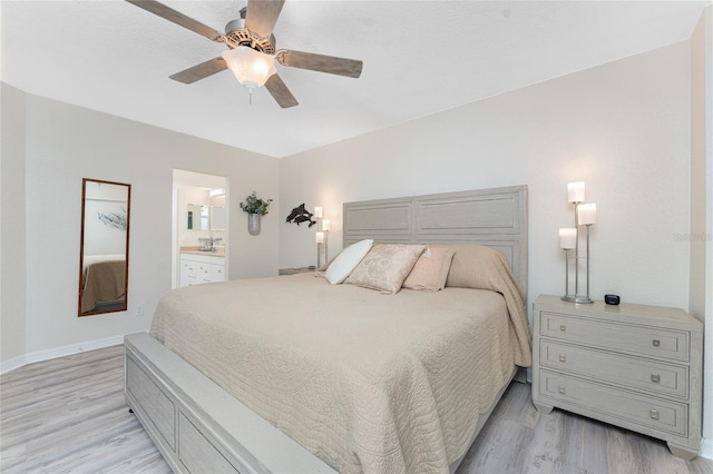 bedroom featuring ceiling fan, baseboards, connected bathroom, and light wood-style floors