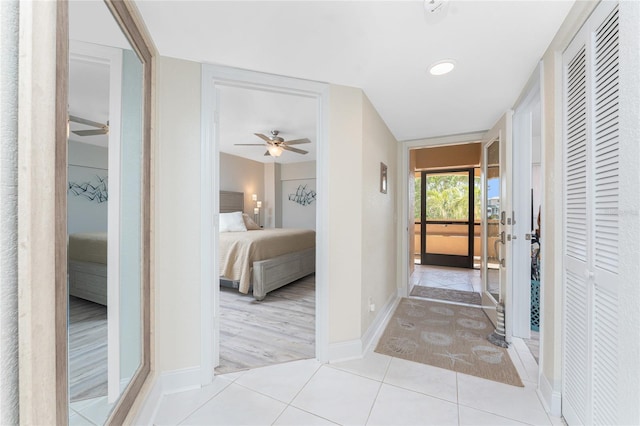 hallway with tile patterned flooring and baseboards