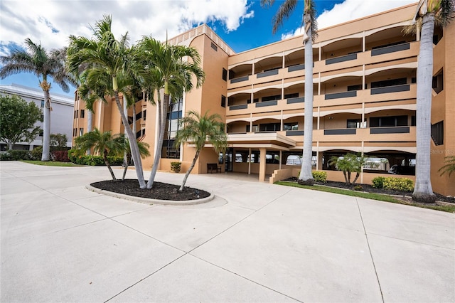 view of building exterior featuring curved driveway