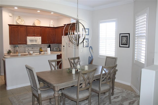 dining area with recessed lighting, light tile patterned flooring, crown molding, baseboards, and a chandelier