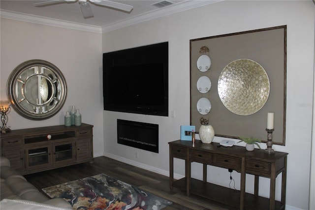 living area with wood finished floors, visible vents, a ceiling fan, a fireplace, and crown molding