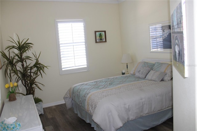 bedroom with baseboards and wood finished floors