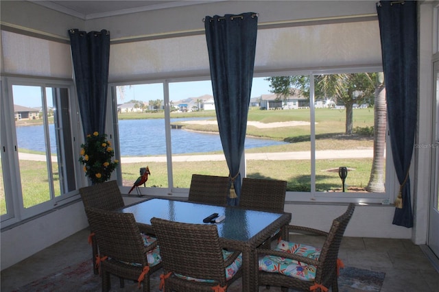 sunroom / solarium featuring plenty of natural light and a water view