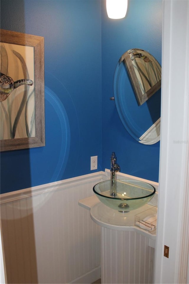 bathroom featuring wainscoting and a sink