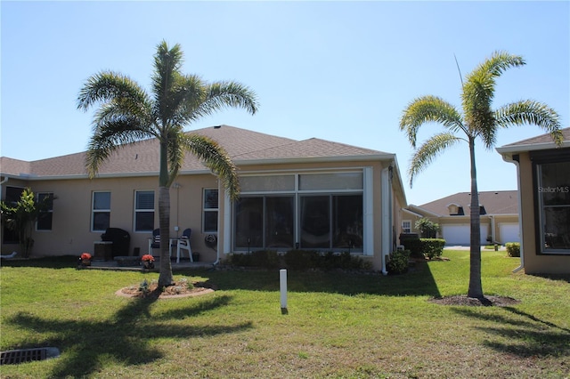 back of house featuring stucco siding and a lawn