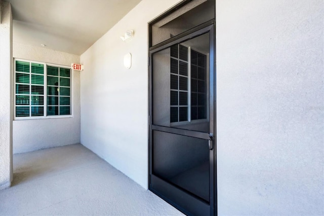 doorway to property with stucco siding