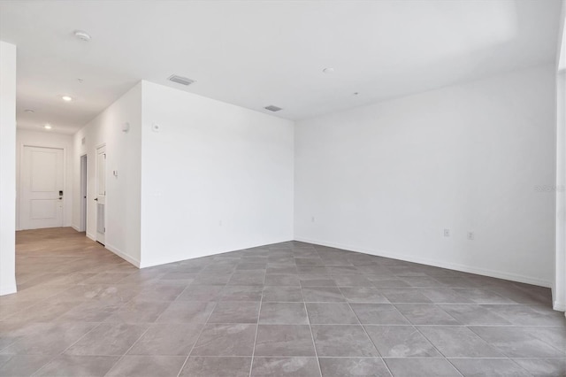 spare room featuring recessed lighting, baseboards, and visible vents