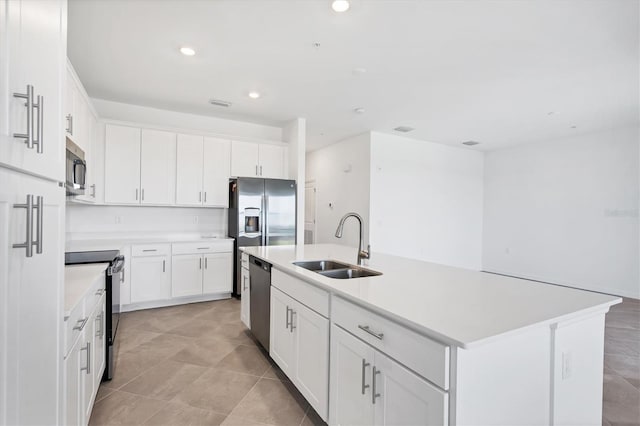 kitchen with light countertops, an island with sink, appliances with stainless steel finishes, and a sink