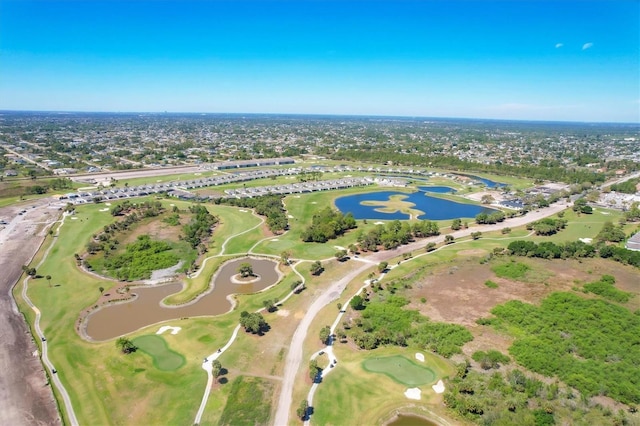 drone / aerial view with a water view and view of golf course