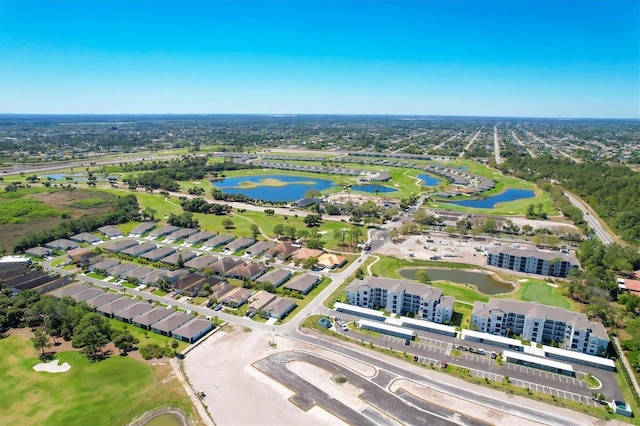 bird's eye view featuring golf course view, a water view, and a residential view