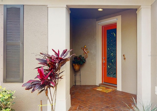 entrance to property featuring stucco siding