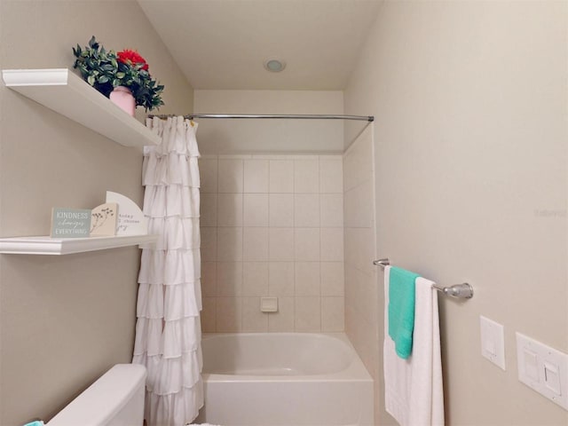 bathroom with shower / bath combination with curtain and toilet