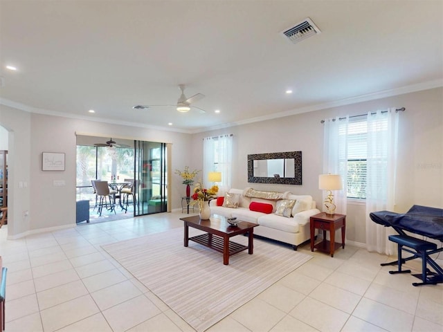 living room featuring light tile patterned flooring, visible vents, a wealth of natural light, and ornamental molding