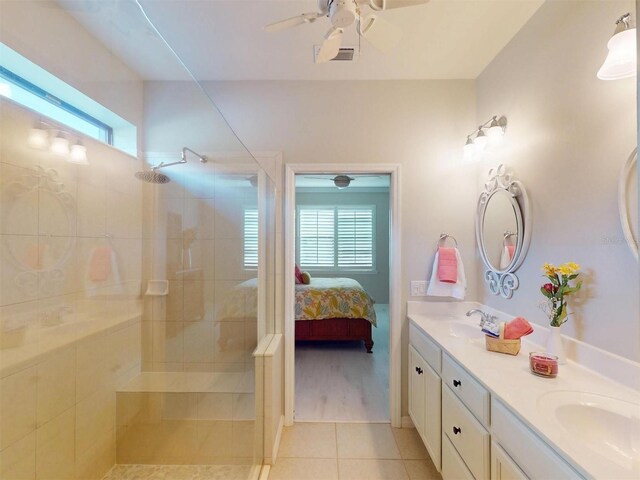 ensuite bathroom with tile patterned floors, connected bathroom, walk in shower, and a sink