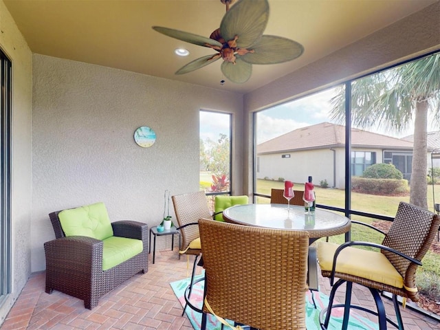 sunroom / solarium with ceiling fan