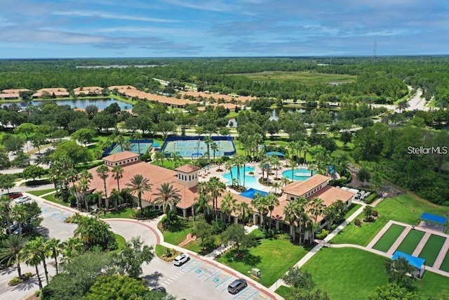 birds eye view of property featuring a wooded view and a water view